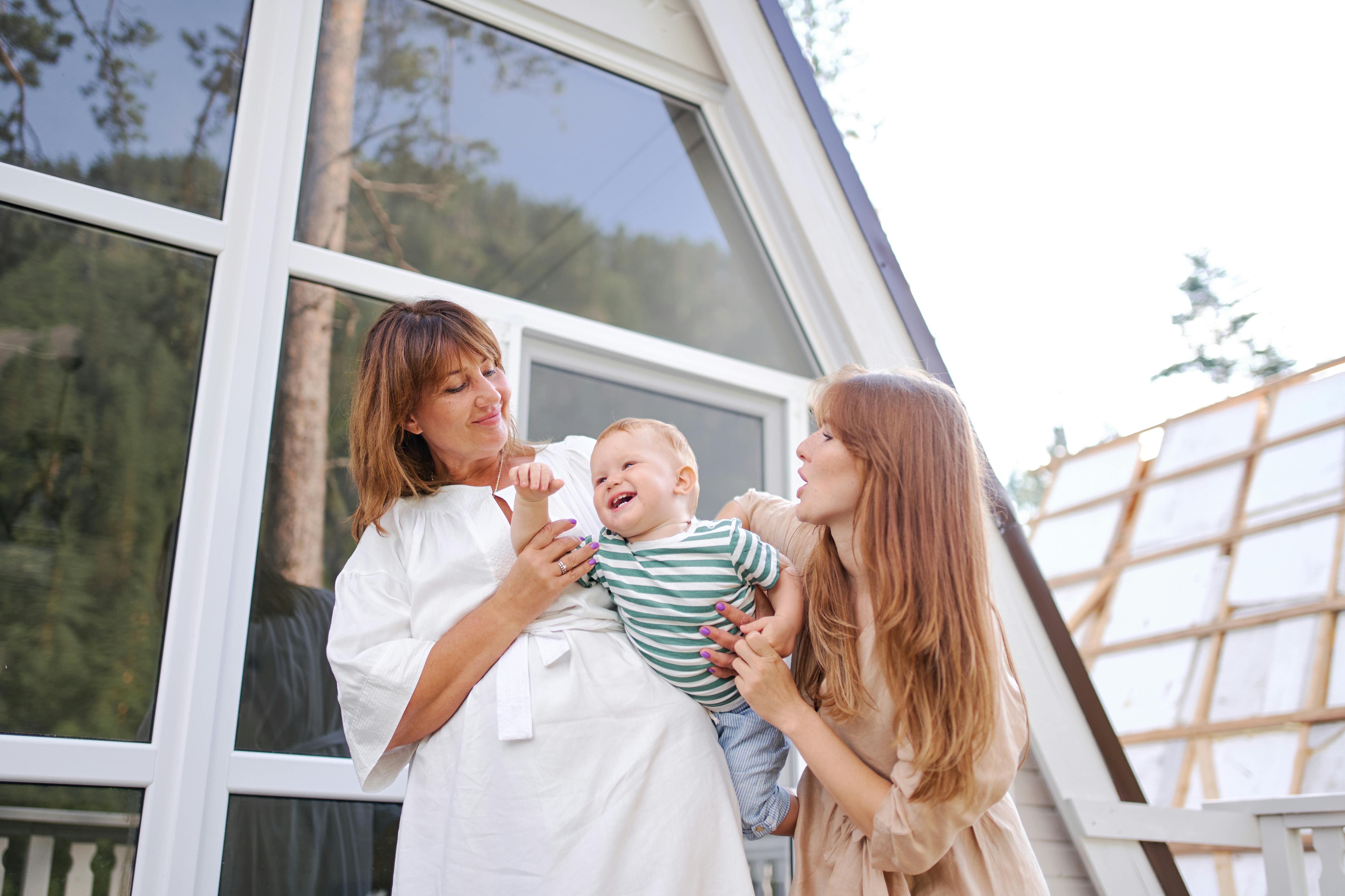 happy women playing with little boy