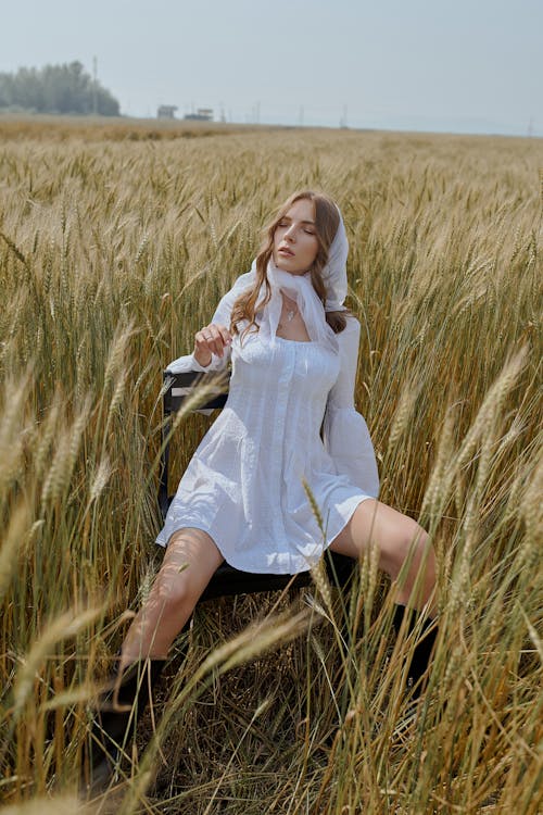 Model Sitting on a Field 