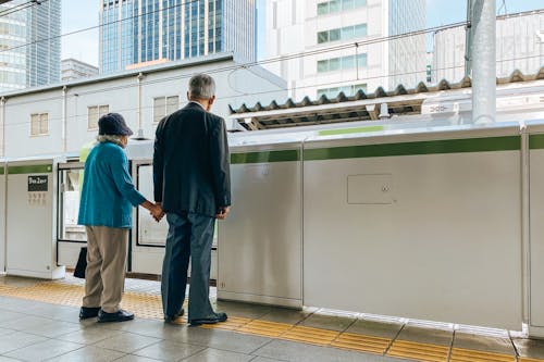 Free Old Couple Waiting at a Train Station Stock Photo