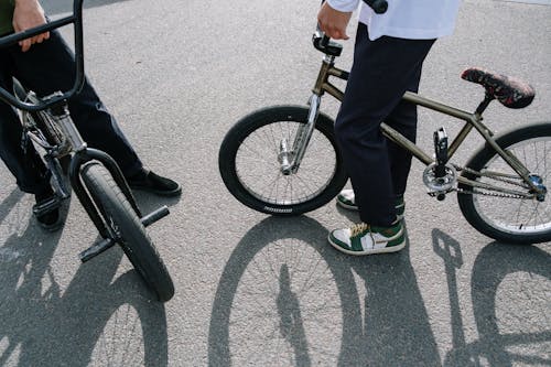 A Person in White Shirt Riding a Bicycle