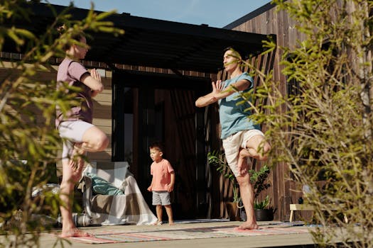 A family practicing yoga in tree pose on a sunlit porch, promoting health and mindfulness.