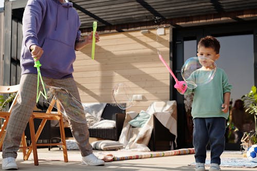 A Young Boy Playing Soap Bubbles