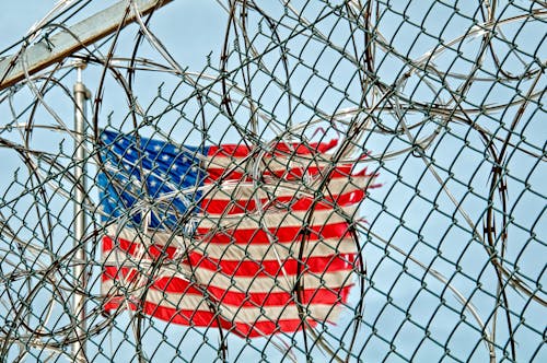 American Flag on Pole Under Blue Sky during Daytime