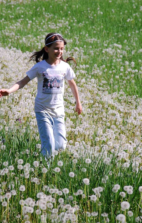 Girl Standing on White Petaled Flowers