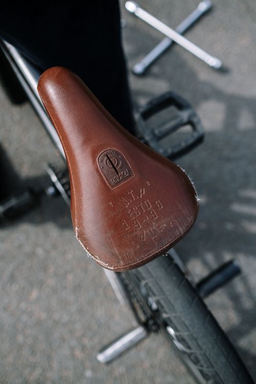 Free Aerial view of a brown leather bicycle seat with bike repair tools. Stock Photo
