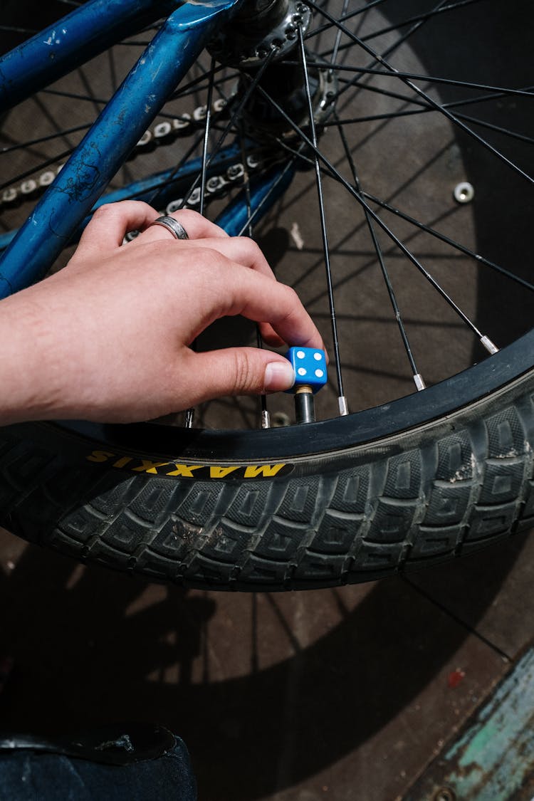 A Person Holding A Bicycle Tire