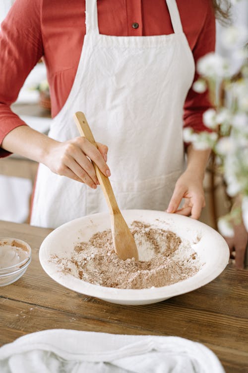 A Person Holding Brown Wooden Ladle