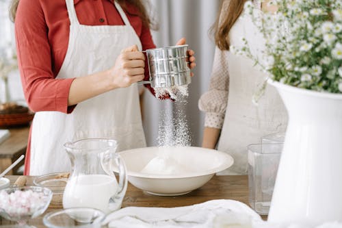 Free Woman Wearing an Apron Holding a Sifter Stock Photo