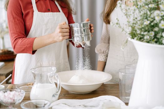 Woman Wearing an Apron Holding a Sifter