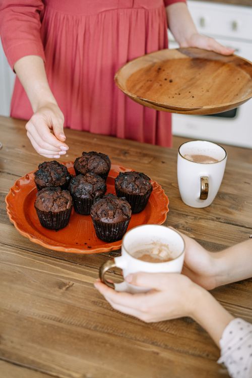 Free Warm chocolate muffins and coffee setup, ideal for cozy mornings. Stock Photo