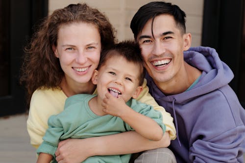 Free A Family Smiling at the Camera Stock Photo