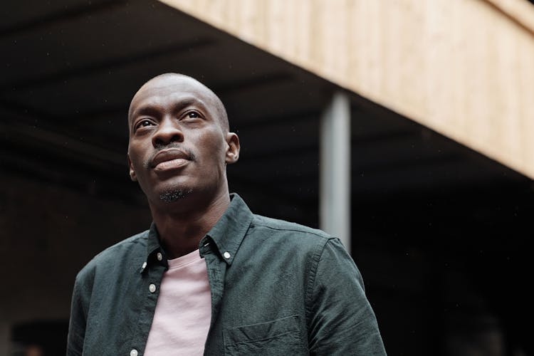 A Man In Black Button Up Shirt Over A White T-shirt