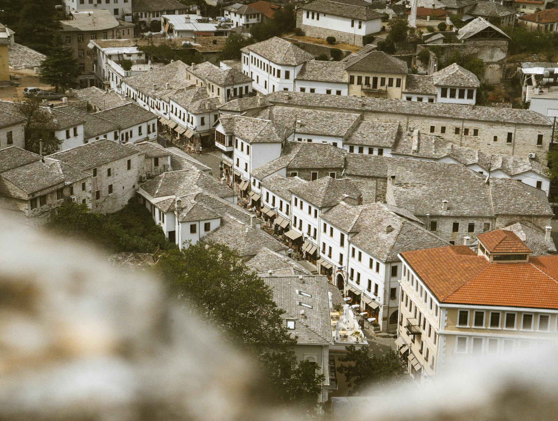 Charming aerial view of a historic village showcasing traditional stone roofing and vintage architecture.