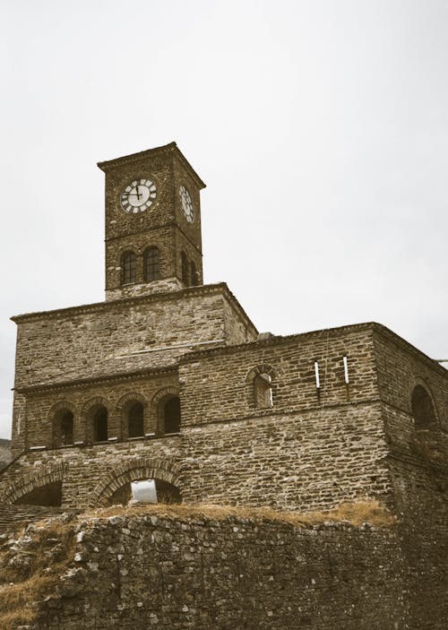 Low Angle Shot of a Castle With a Clock on Top