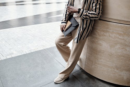 Stylish Man leaning on a Column 