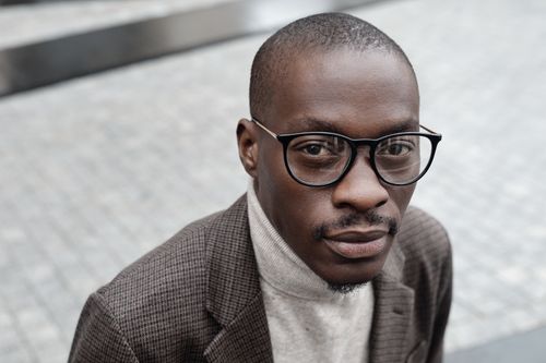 Free Portrait of a bald African American man in a plaid blazer and turtleneck. Stylish and confident. Stock Photo
