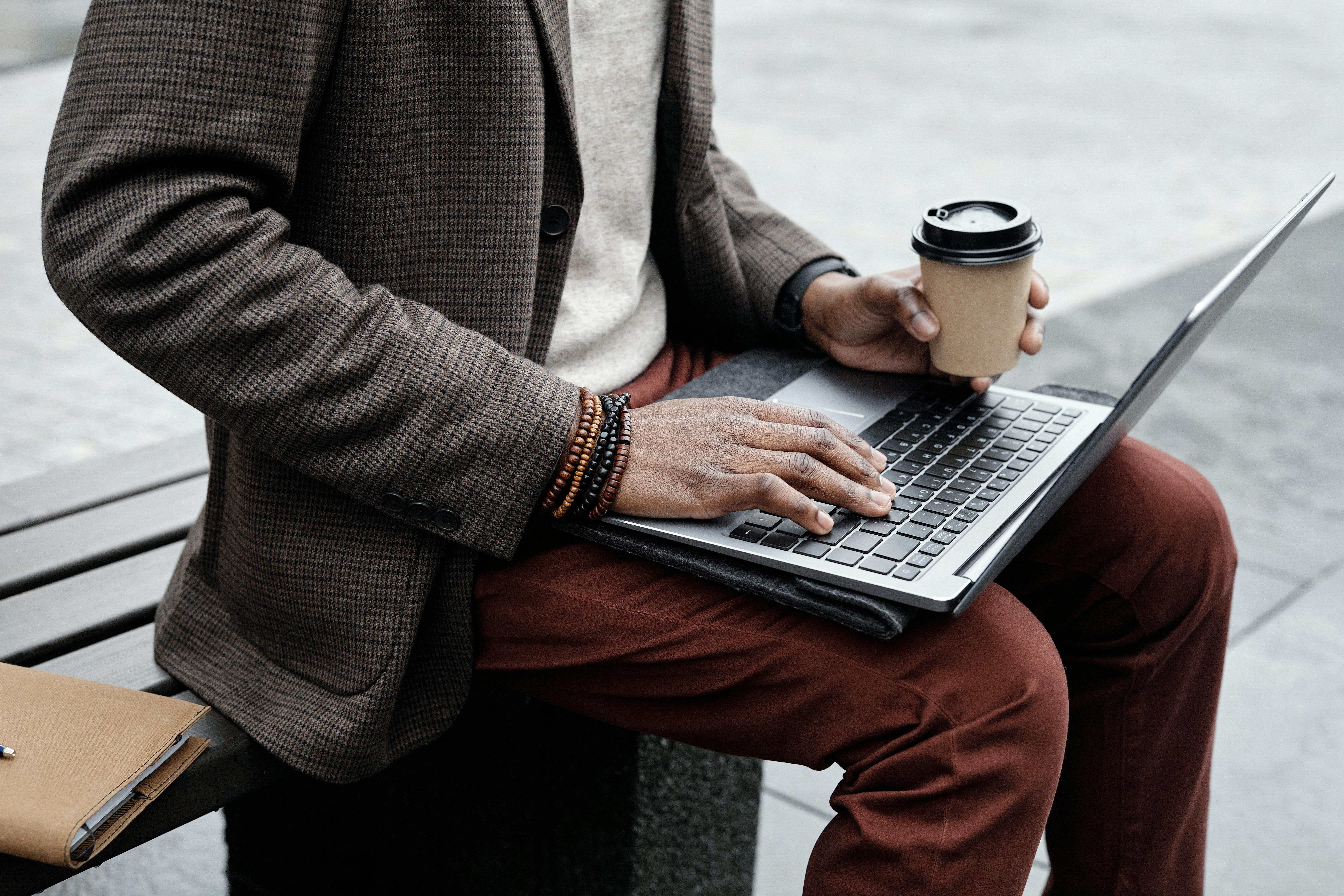 Freelancer working on laptop with coffee in a stylish remote setup