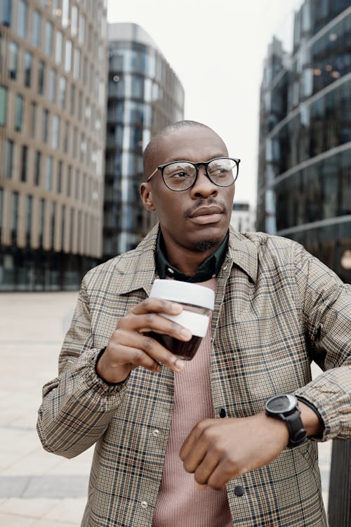 Free A Stylish Businessman Holding a Cup of Coffee Stock Photo