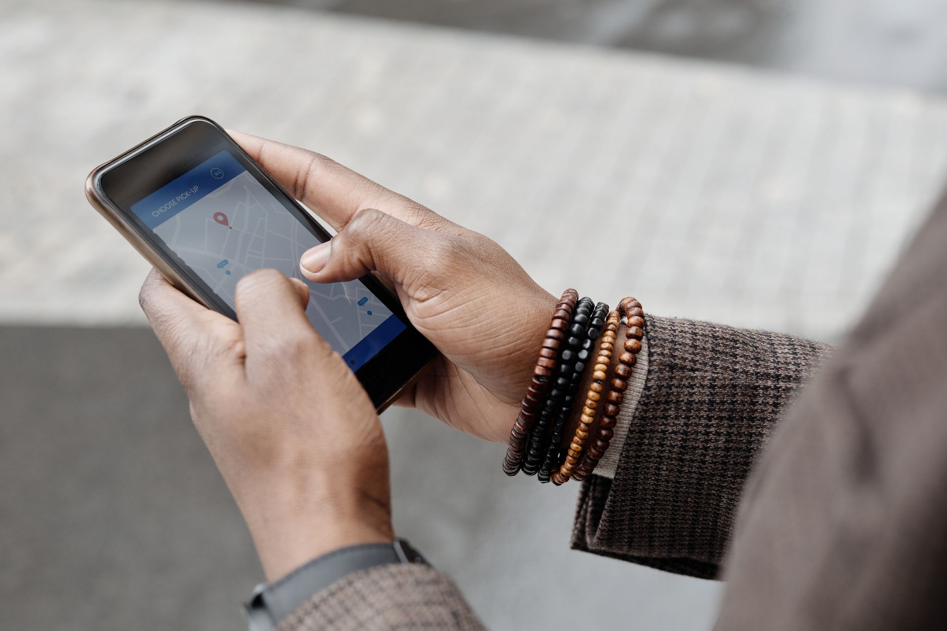 SEO Page Hands using GPS map app on smartphone outdoors