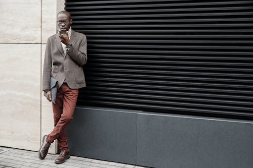 A Man Talking on the Phone While Holding an Envelope