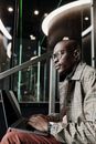 A Stylish Businessman Using a Laptop