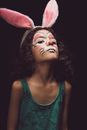 Woman in Green Tank Top With Pink and White Face Paint