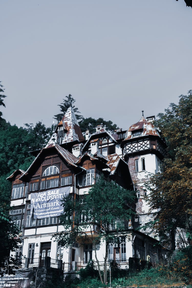 Old Building With Banner For Sale