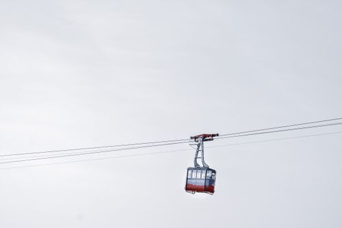 Free Cable car riding on ropeway in wild nature against gray cloudy sky at daytime Stock Photo