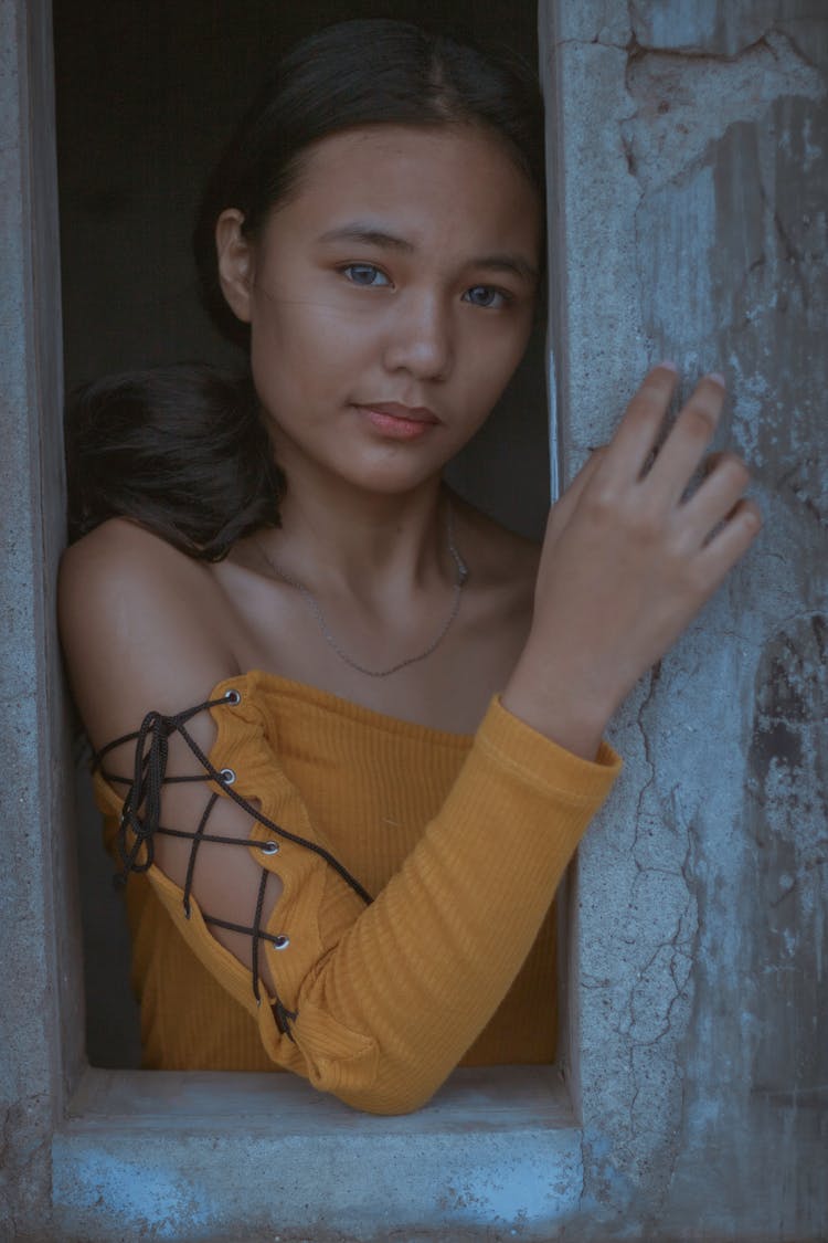 Teen Ethnic Stylish Girl Touching Concrete Wall