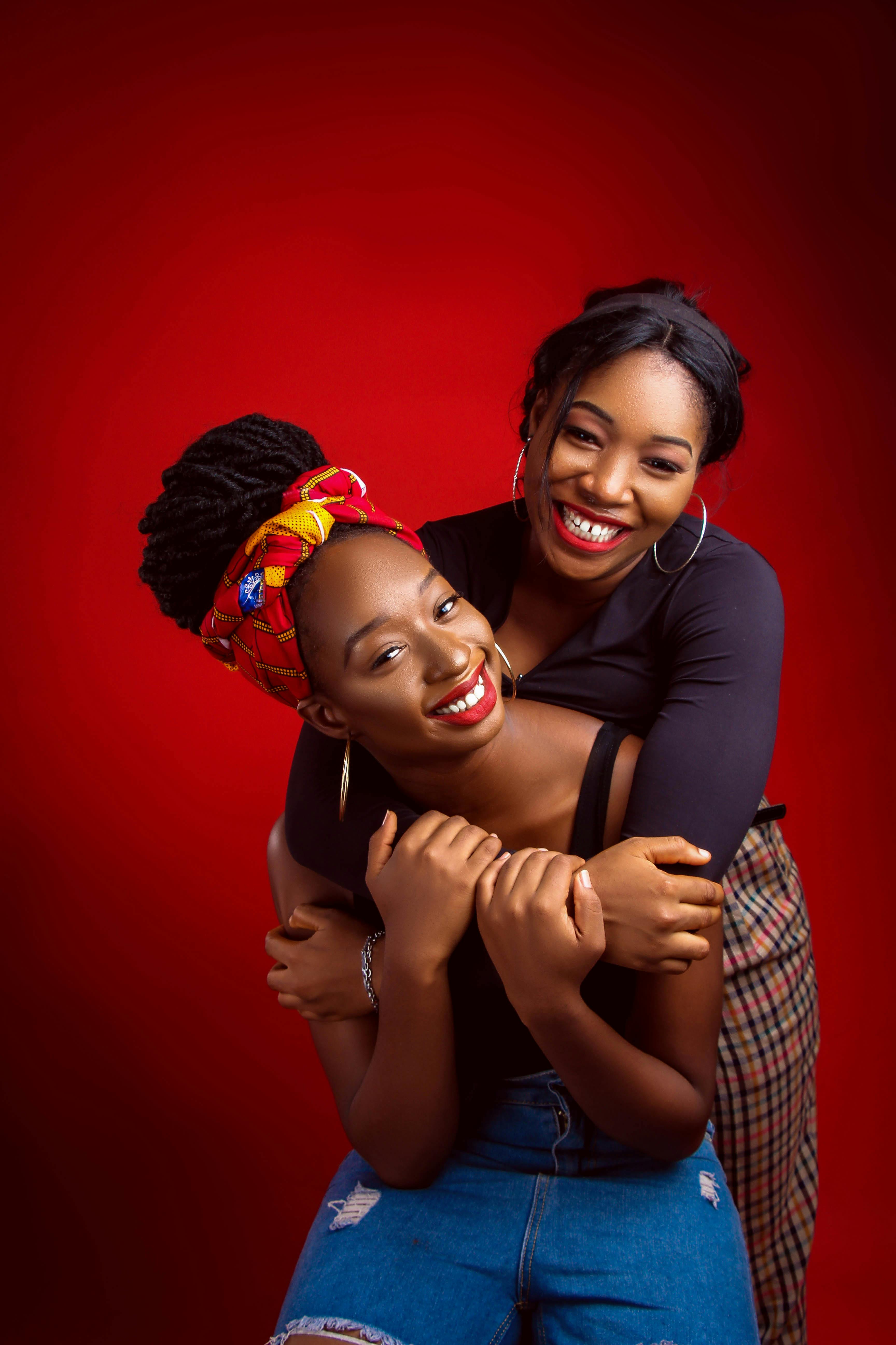 smiling black women embracing in studio