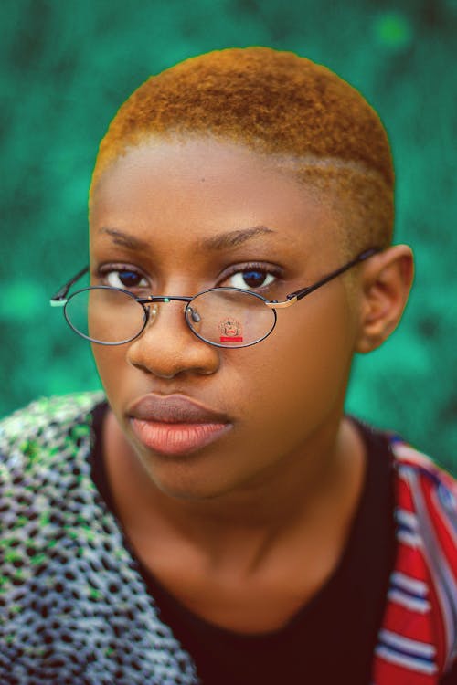 Free Serious African American female with short hair and brown eyes in eyeglasses looking at camera Stock Photo