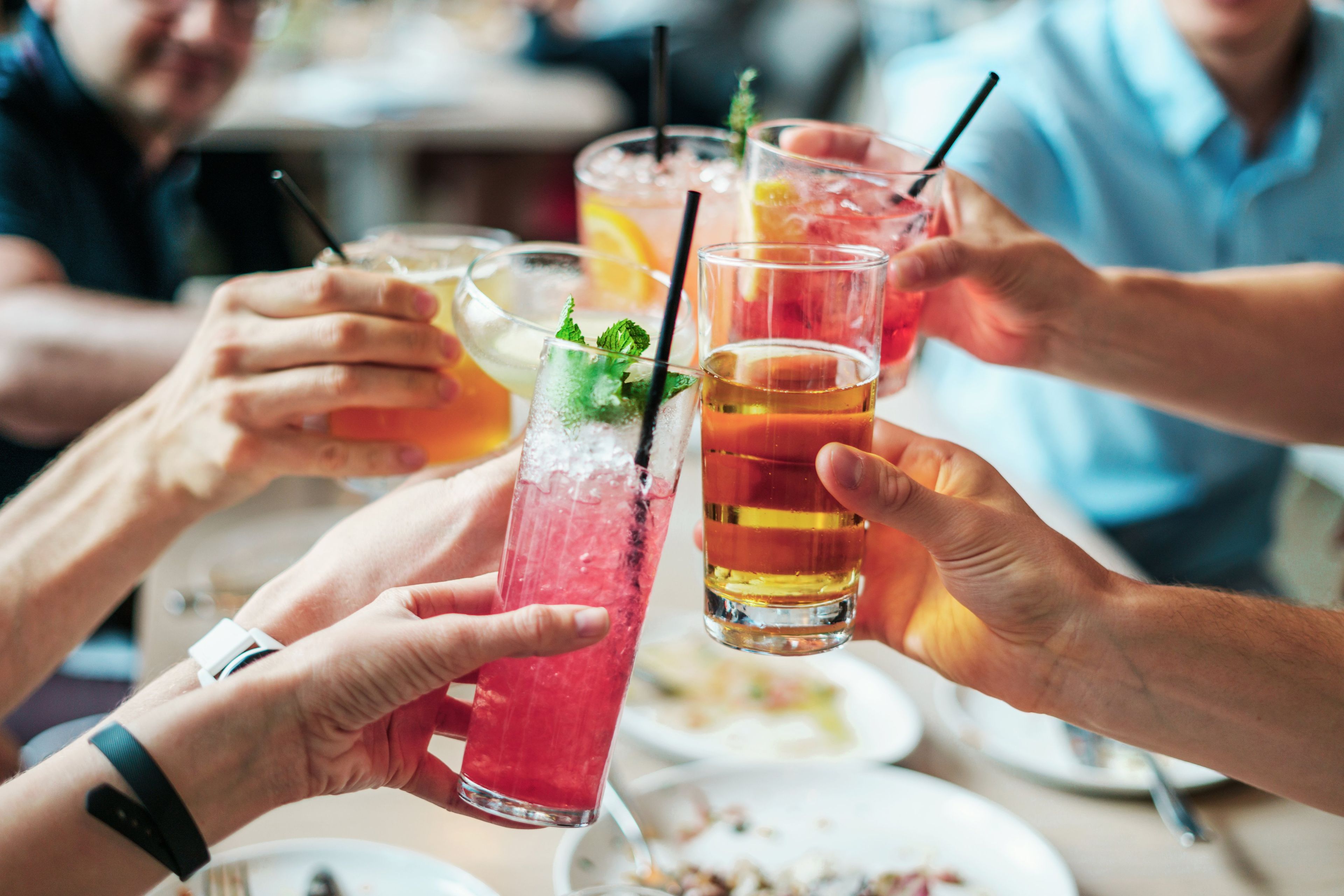 Glasses raised over a crowded table