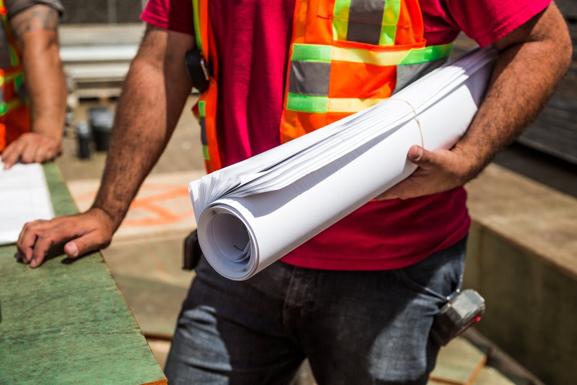 Person Holding Drafting Paper