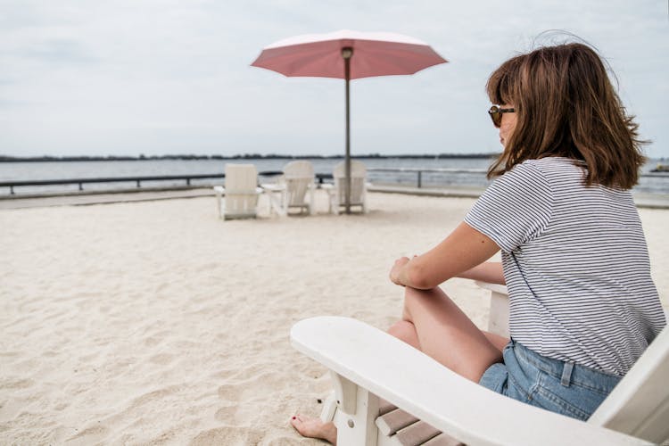 Woman Sitting On Beach Chair