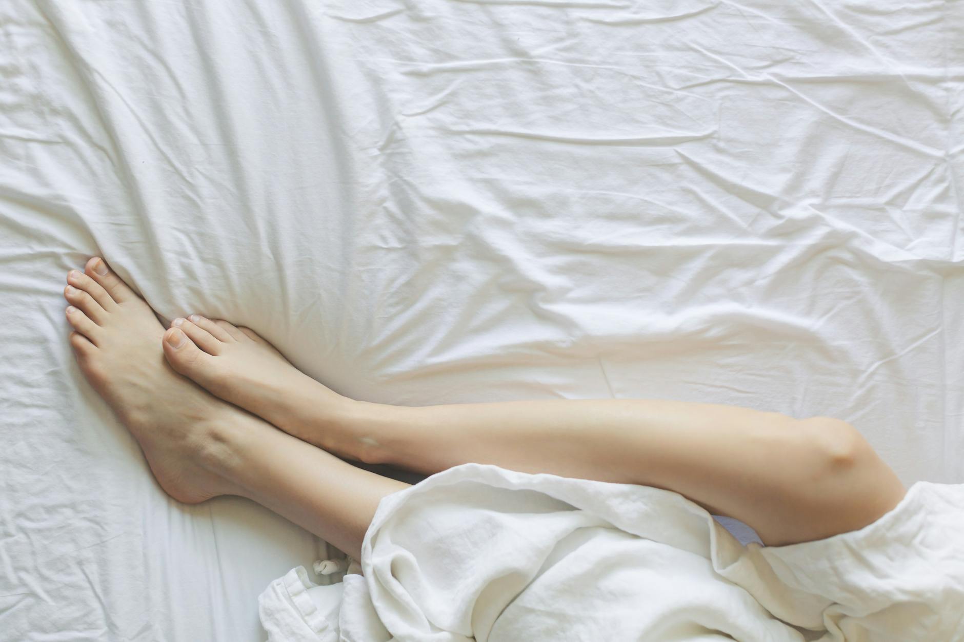 Girl on afloat bed with white sheets