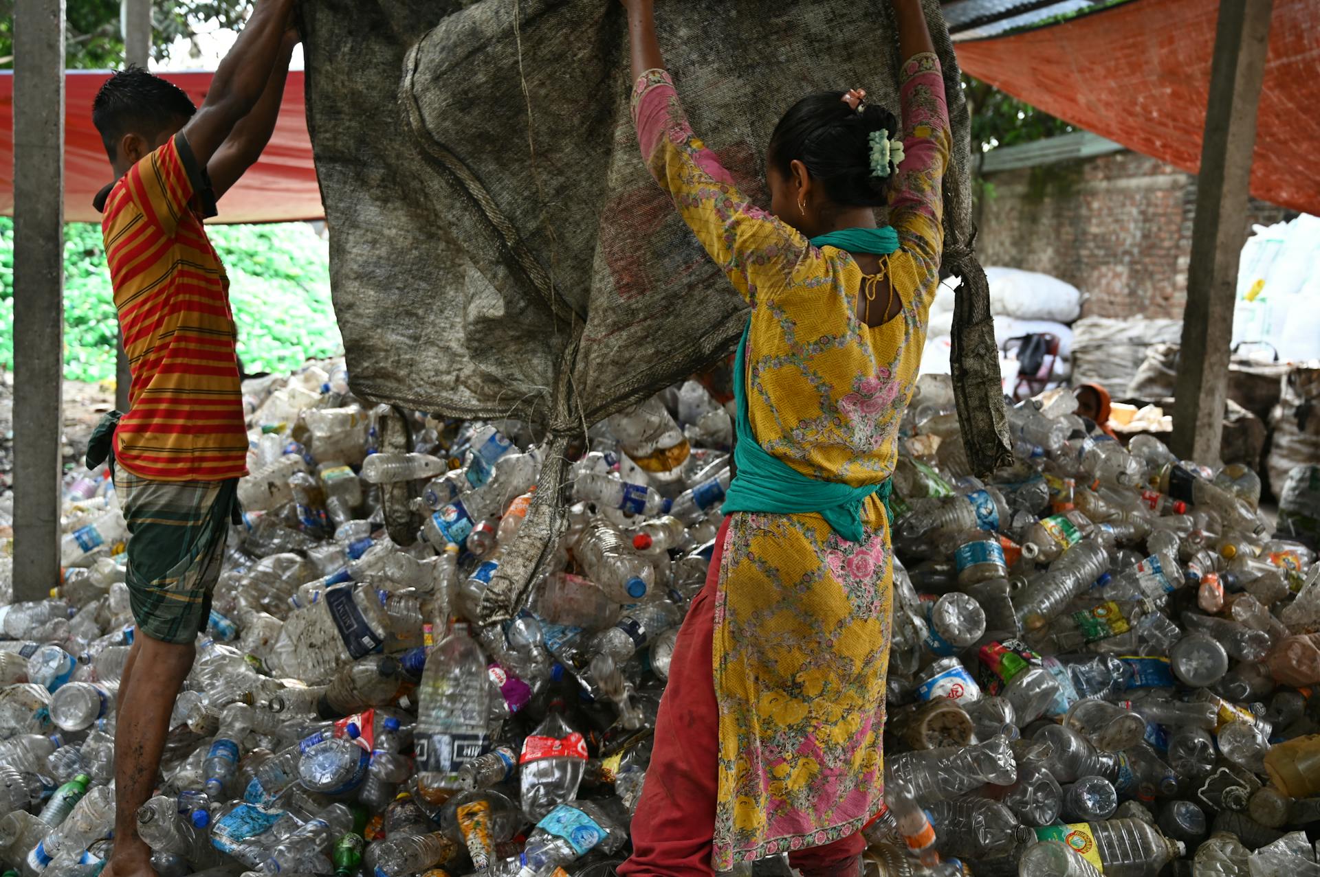 People Piling Up PET Bottles