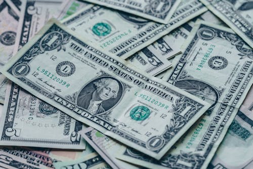 Free Close-up image of stacked US dollar bills representing wealth and finance. Stock Photo