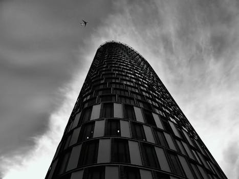 现代摩天大楼与飞机剪影构成了一幅戏剧性的黑白照片