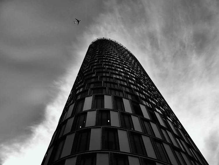 Airplane Flying Over Building Structure