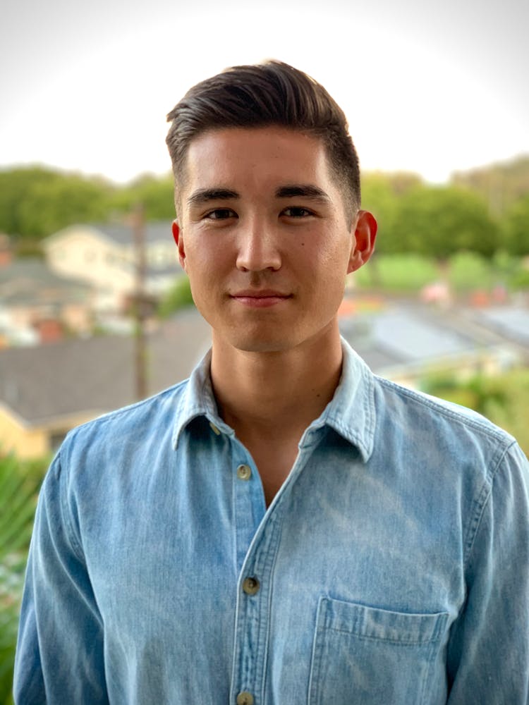 Man In Blue Denim Button Up Shirt Seriously Looking At Camera