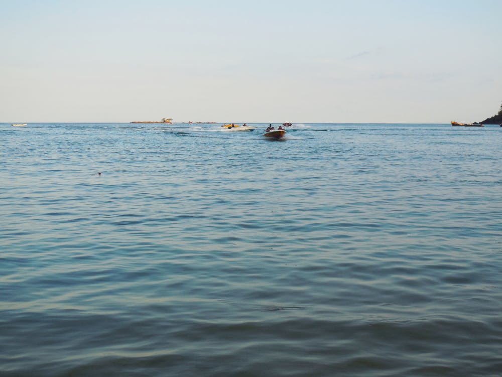 People Riding on Boat on Sea