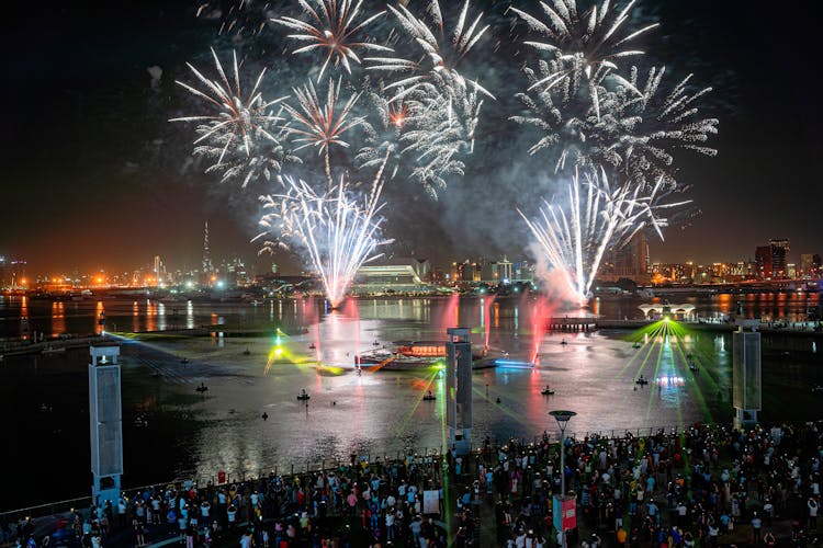 People Watching Fireworks Display At Night