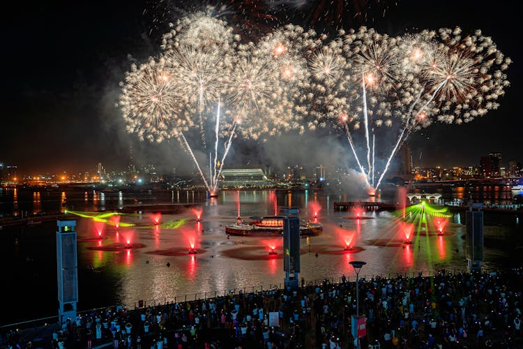 A Crowd Of Spectators Watching A Fireworks Display