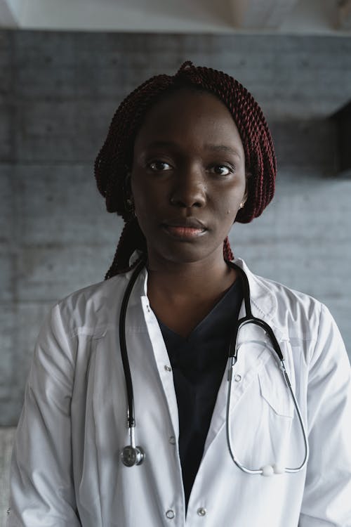 Young Female Doctor in a White Coat and a Stethoscope 