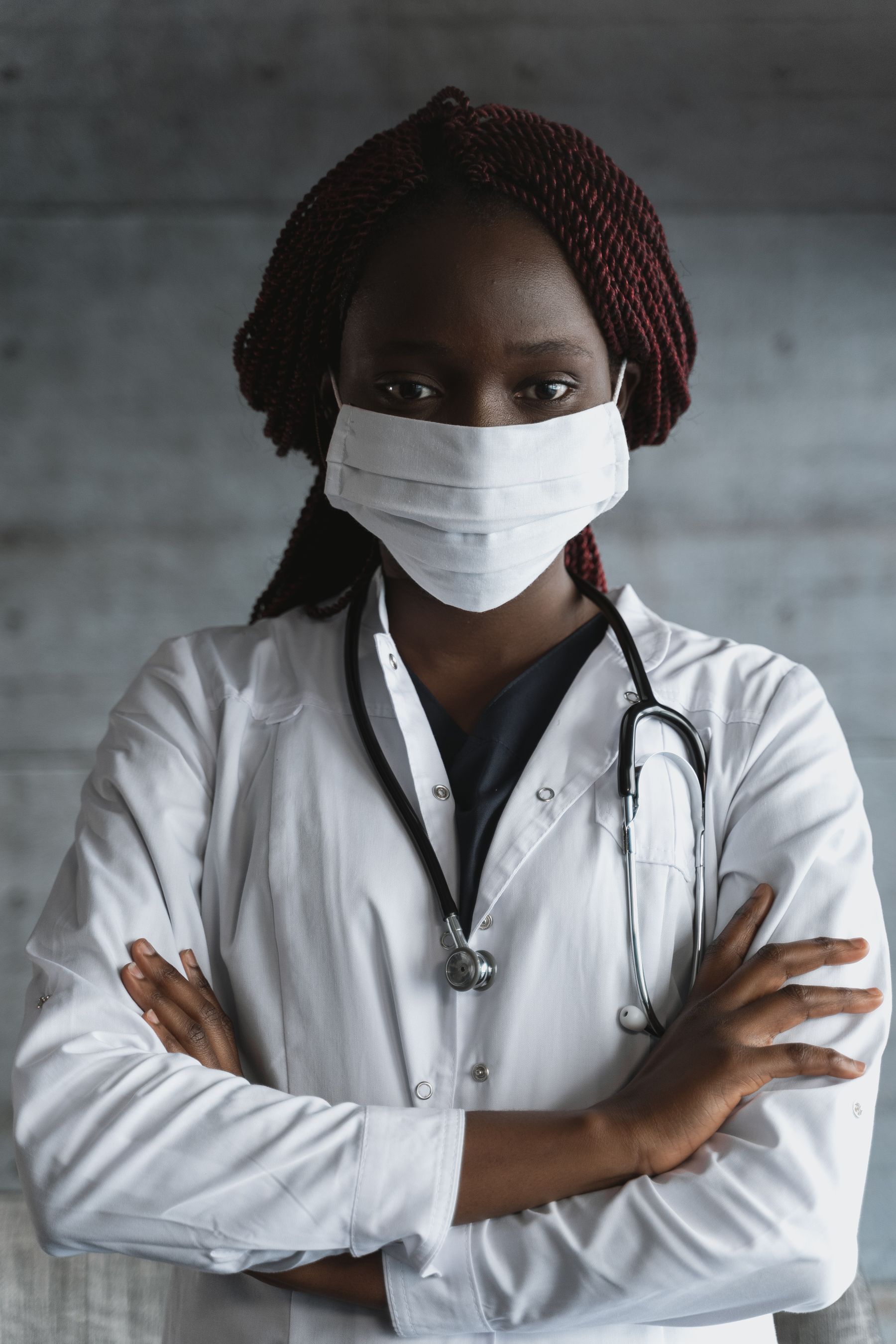 Dr. Alex Morgan, dermatology specialist, standing in a contemporary clinic