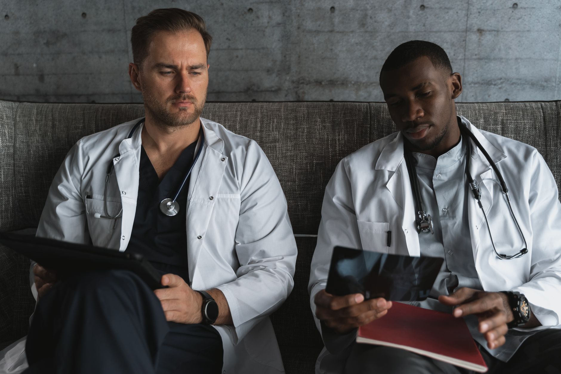 Two doctors analyze X-ray films in a medical office for diagnosis.