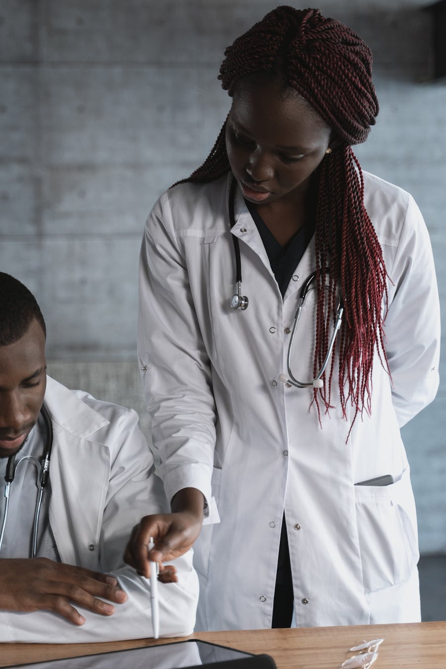 African medical practitioners collaborating over a tablet