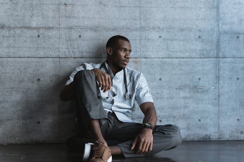 Tired Doctor sitting on a Floor