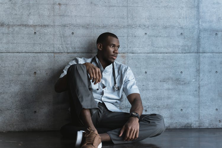 Tired Doctor Sitting On A Floor