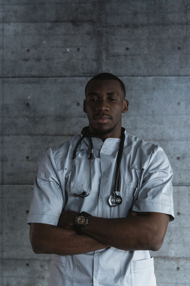 Portrait of Dr. James Okafor in surgical scrubs